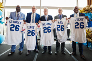 Kendrick, Kehoe, Sherman, Hall, and Lucas holding up custom Royals jerseys with their last names on it.
