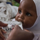 A child receives food rations due to UNICEF's support