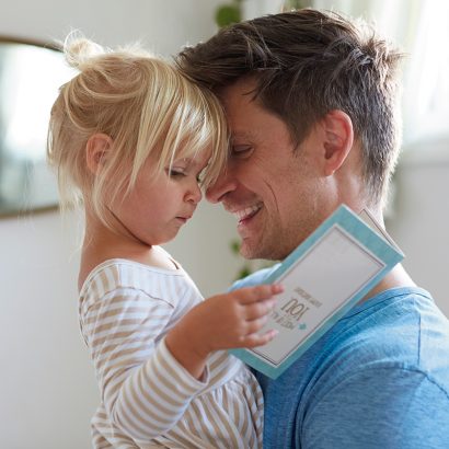 Father holding daughter