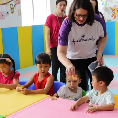 Hallmark employee Kristin Edie works with children of factory workers as part of the Family Friendly Spaces program, which brings children to the facility, hosting them in a safe and educational environment. Parents are able to see their children during the summer with this program, who otherwise would not be able to.