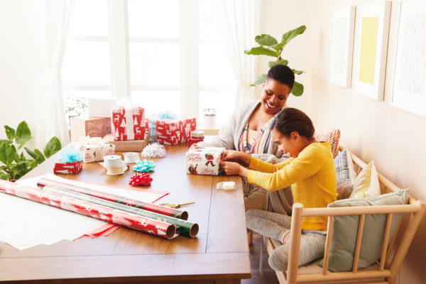 Image of mother and daughter wrapping gifts