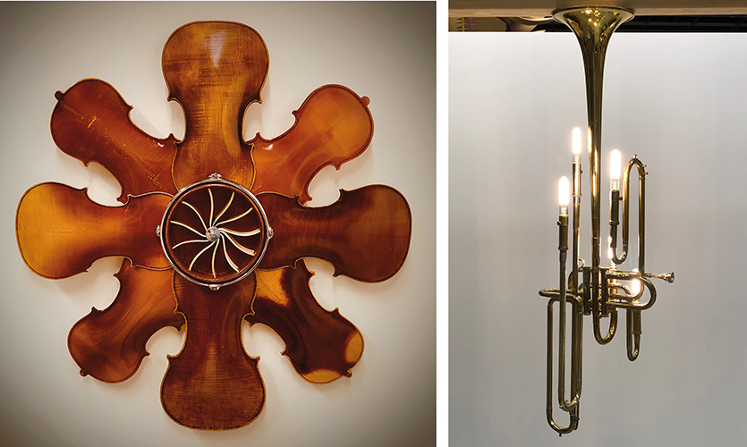 Blown glass art. One piece is glass violins in circle that looks like a clock. The other piece is glass light bulbs in a trombone reshaped to be a handing light.