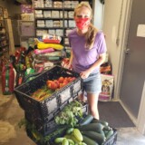 Emily dropping off large crates of fresh produce