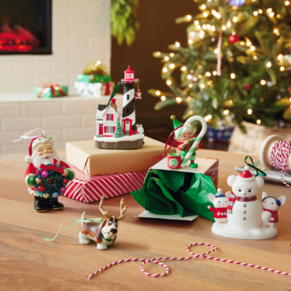 Hallmark Keepsake Ornaments include Santa, a dog with reindeer antlers, a mouse snowman, an elf painting a candy cane, and a lighthouse with Santa.